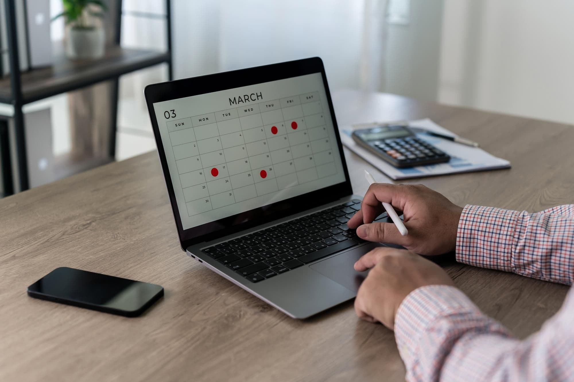 planning schedule on laptop marking dates and appointments business agenda deadlines and meeting reminders organized for productivity at a modern workspace time blocking planner
