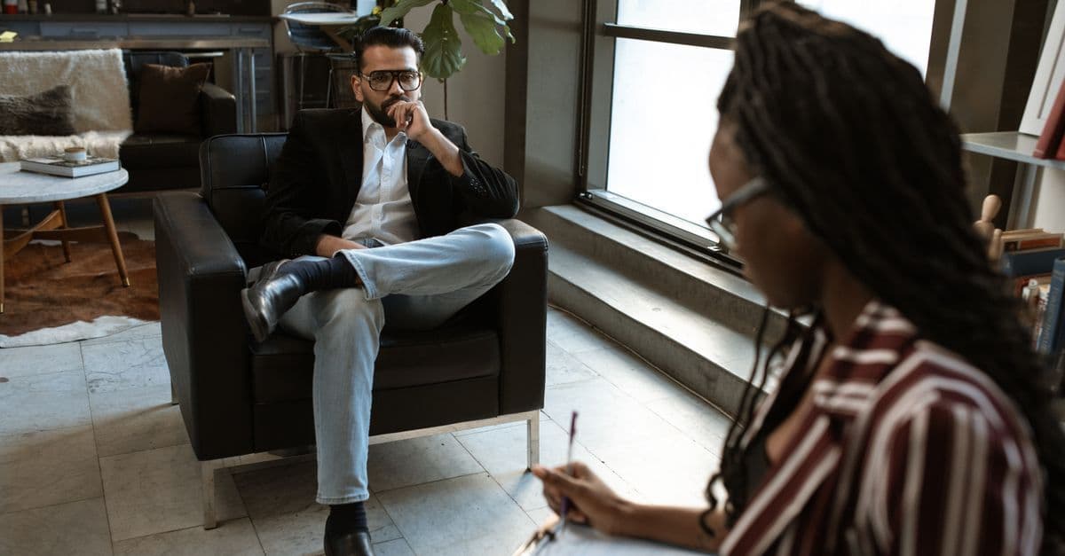 A man and woman engaged in an interview in a stylish modern office.
