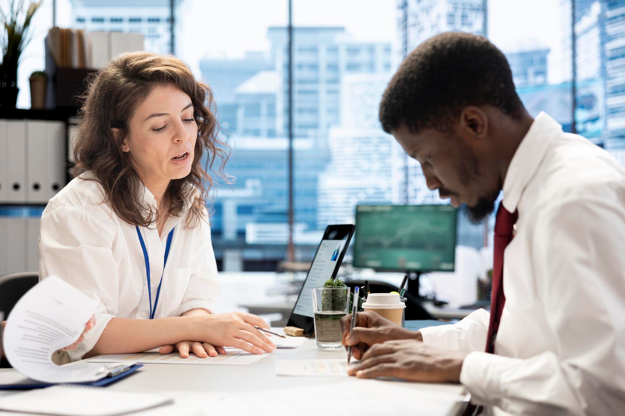 HR employee signing contract with applicant after job interview