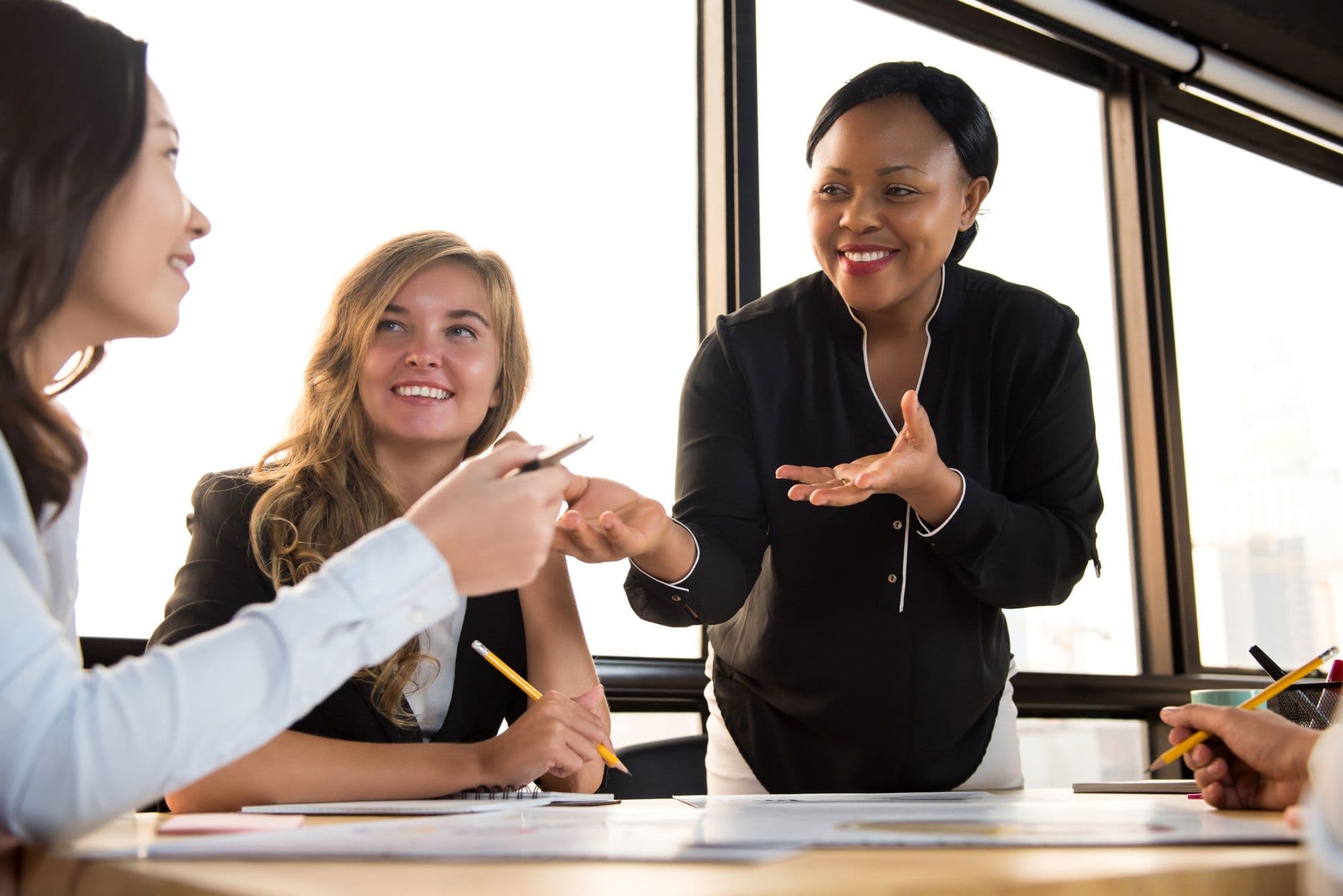 Friendly black businesswoman supporting her colleague in the meeting