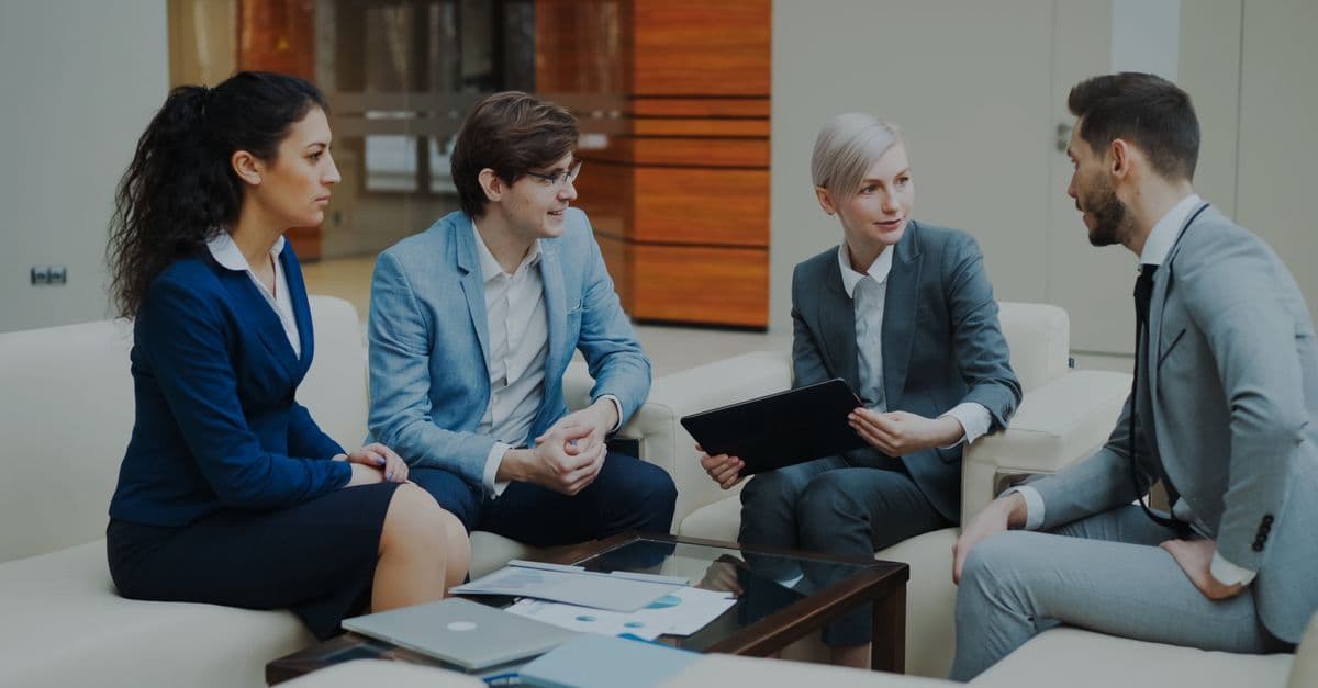 Group of professionals discussing strategy at an office.