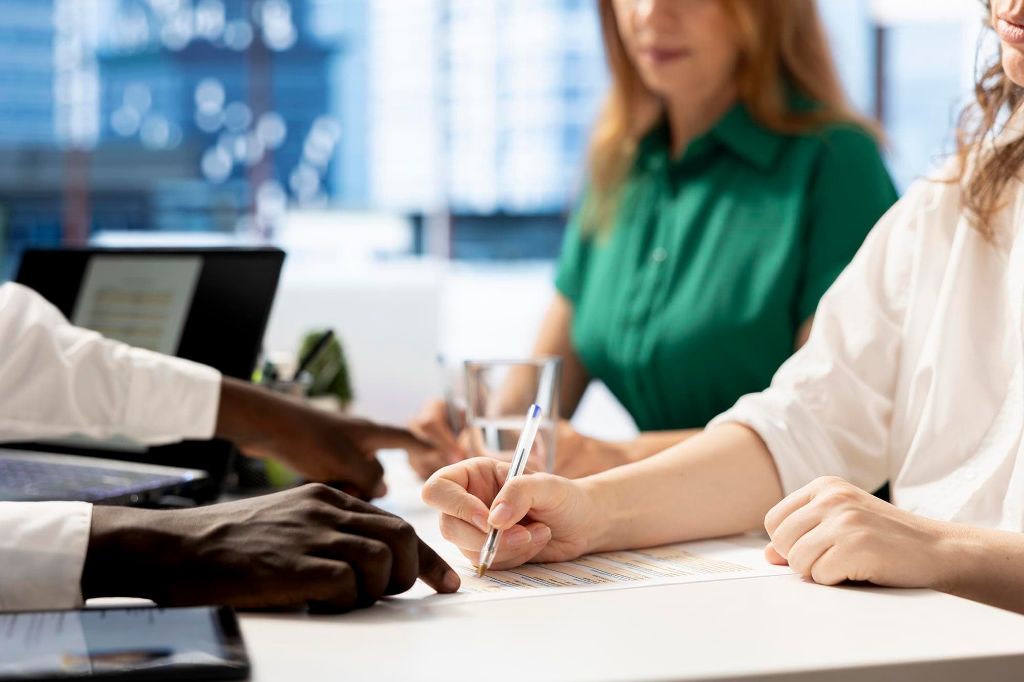 HR manager helped by assistant signing contract after hiring job candidate